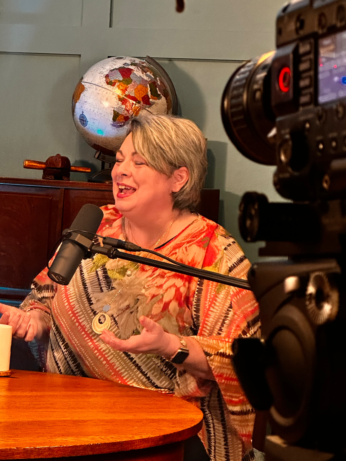 Patsy Alston speaking into a studio microphone